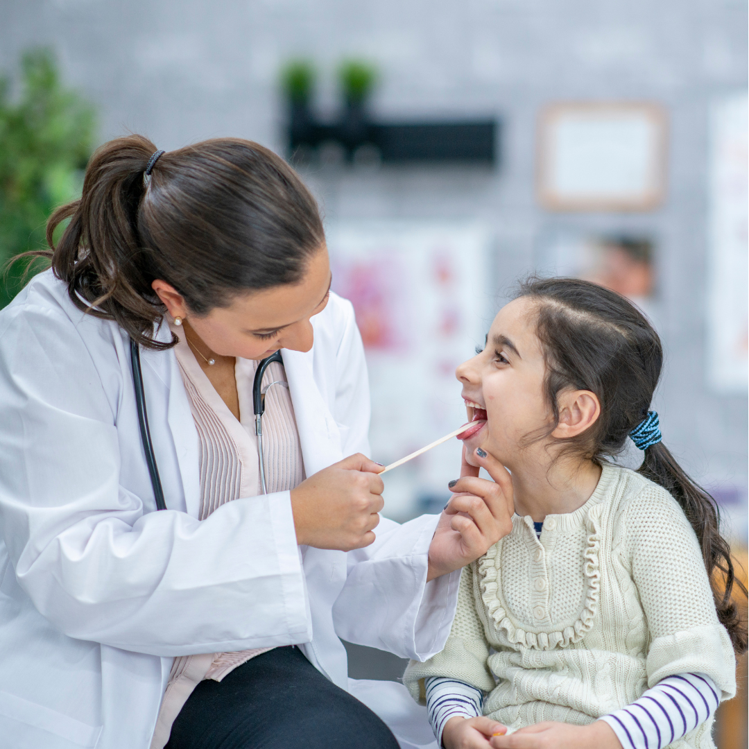 Pediatric ENT specialist in Chembur, Dr Swetal Mahajan, examining throat of young girl with tonsils and throat infection..png